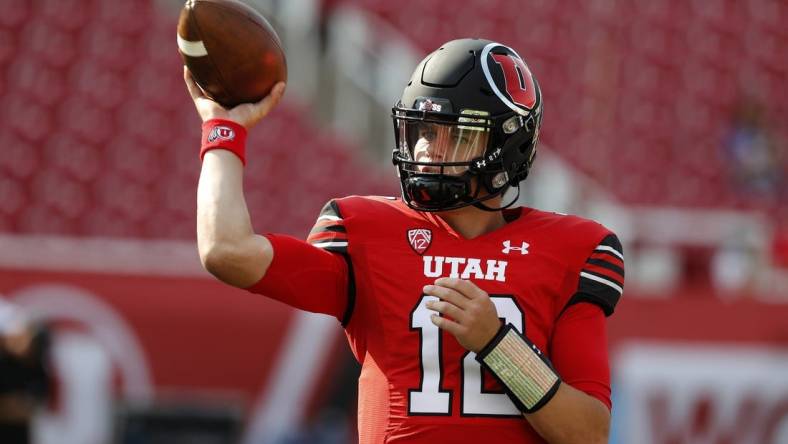 Sep 2, 2021; Salt Lake City, Utah, USA; Utah Utes quarterback Charlie Brewer (12) warm up prior to their game against the Weber State Wildcats  at Rice-Eccles Stadium. Mandatory Credit: Jeffrey Swinger-USA TODAY Sports