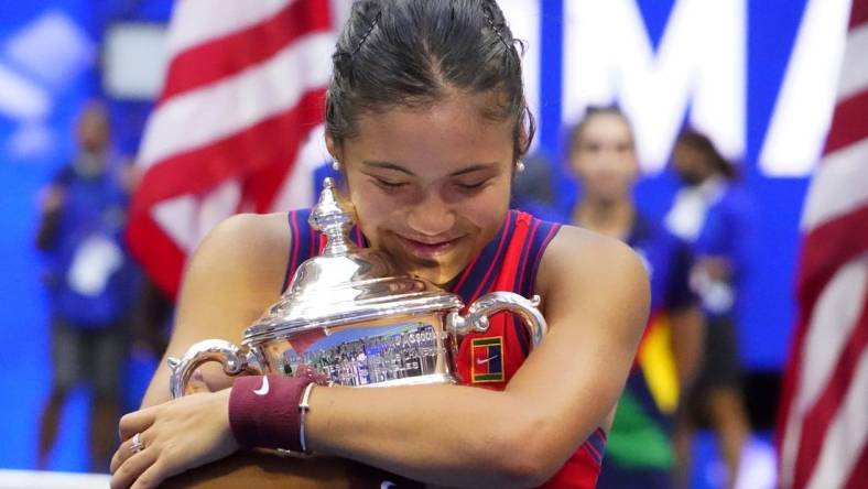 Sep 11, 2021; Flushing, NY, USA; Emma Raducanu of Great Britain celebrates with the championship trophy after her match against Leylah Fernandez of Canada (not pictured) in the women's singles final on day thirteen of the 2021 U.S. Open tennis tournament at USTA Billie Jean King National Tennis Center. Mandatory Credit: Robert Deutsch-USA TODAY Sports