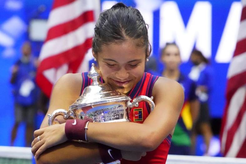 Sep 11, 2021; Flushing, NY, USA; Emma Raducanu of Great Britain celebrates with the championship trophy after her match against Leylah Fernandez of Canada (not pictured) in the women's singles final on day thirteen of the 2021 U.S. Open tennis tournament at USTA Billie Jean King National Tennis Center. Mandatory Credit: Robert Deutsch-USA TODAY Sports