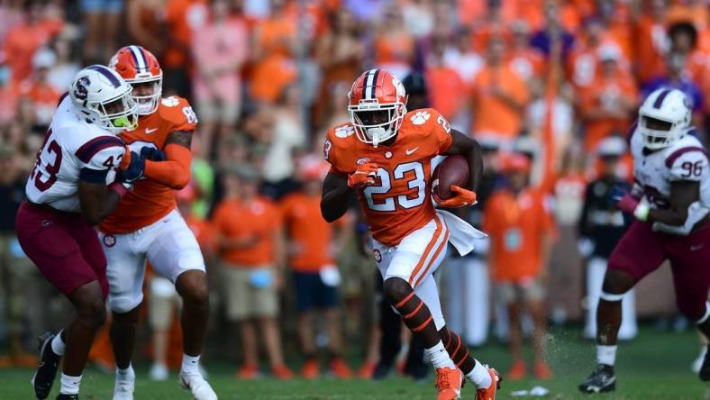 Sep 11, 2021; Clemson, South Carolina, USA; Clemson Tigers running back Lyn-J Dixon (23) carries the ball against the South Carolina State Bulldogs during the first quarter at Memorial Stadium. Mandatory Credit: Adam Hagy-USA TODAY Sports