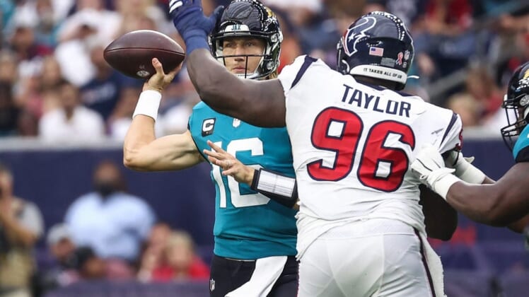 Sep 12, 2021; Houston, Texas, USA; Jacksonville Jaguars quarterback Trevor Lawrence (16) attempts a pass as Houston Texans defensive tackle Vincent Taylor (96) defends during the game at NRG Stadium. Mandatory Credit: Troy Taormina-USA TODAY Sports