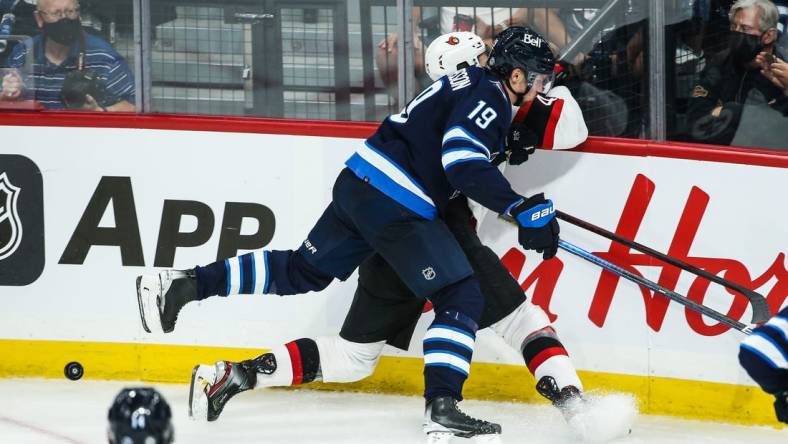 Sep 26, 2021; Winnipeg, Manitoba, CAN;  Winnipeg Jets forward David Gustafsson (19) boards Ottawa Senators forward Mark Kastalic (47) during the third period at Canada Life Centre. Mandatory Credit: Terrence Lee-USA TODAY Sports