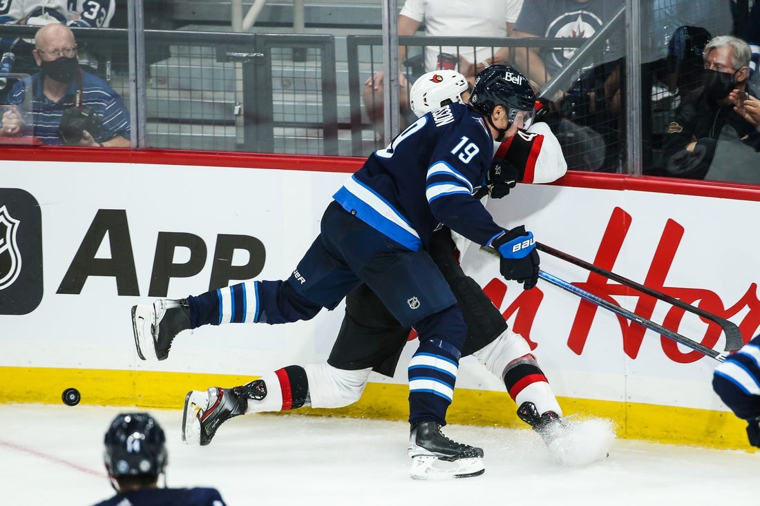 Sep 26, 2021; Winnipeg, Manitoba, CAN;  Winnipeg Jets forward David Gustafsson (19) boards Ottawa Senators forward Mark Kastalic (47) during the third period at Canada Life Centre. Mandatory Credit: Terrence Lee-USA TODAY Sports