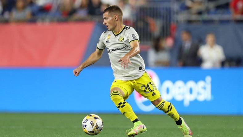 Sep 18, 2021; Foxborough, Massachusetts, USA; Columbus Crew midfielder Alexandru Matan (20) possesses the ball against the New England Revolution at Gillette Stadium. Mandatory Credit: Paul Rutherford-USA TODAY Sports