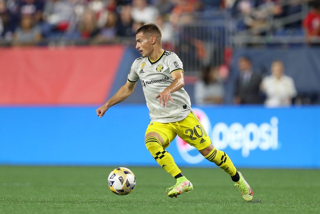 Sep 18, 2021; Foxborough, Massachusetts, USA; Columbus Crew midfielder Alexandru Matan (20) possesses the ball against the New England Revolution at Gillette Stadium. Mandatory Credit: Paul Rutherford-USA TODAY Sports