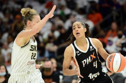 Oct 10, 2021; Phoenix, Arizona, USA; Phoenix Mercury guard Skylar Diggins-Smith (4) dribbles against Chicago Sky guard Courtney Vandersloot (22) during the first half of game one of the 2021 WNBA Finals at Footprint Center. Mandatory Credit: Joe Camporeale-USA TODAY Sports