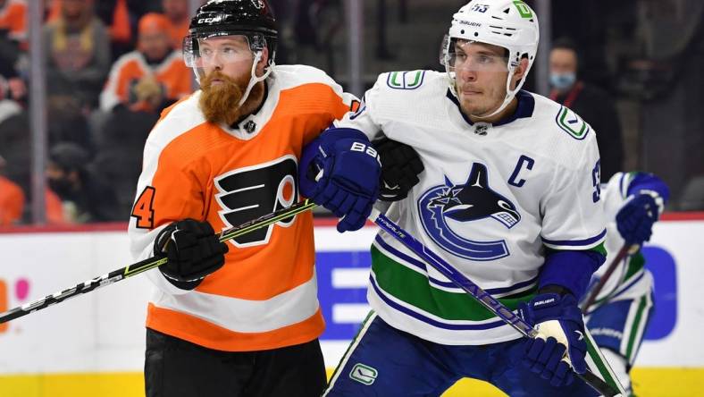 Oct 15, 2021; Philadelphia, Pennsylvania, USA; Vancouver Canucks center Bo Horvat (53) and Philadelphia Flyers defenseman Ryan Ellis (94) battle for position at Wells Fargo Center. Mandatory Credit: Eric Hartline-USA TODAY Sports