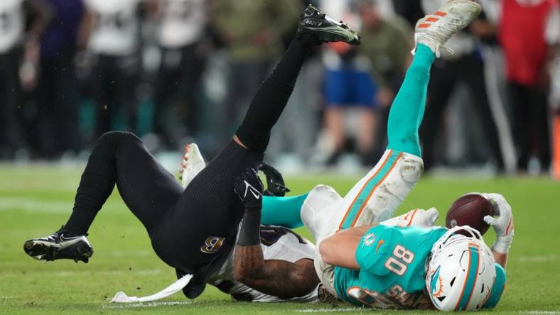 Nov 11, 2021; Miami Gardens, Florida, USA; Miami Dolphins tight end Adam Shaheen (80) comes down with a catch while being defended by Baltimore Ravens safety Chuck Clark (36) during the first half at Hard Rock Stadium. Mandatory Credit: Jasen Vinlove-USA TODAY Sports