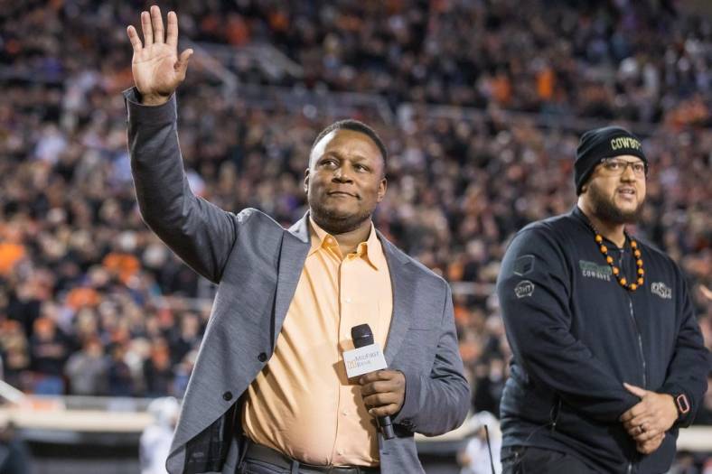 Nov 13, 2021; Stillwater, Oklahoma, USA;  Barry Sanders acknowledges the Oklahoma State Cowboys crowd before the game against the TCU Horned Frogs at Boone Pickens Stadium. OSU won 63-17. Mandatory Credit: Brett Rojo-USA TODAY Sports