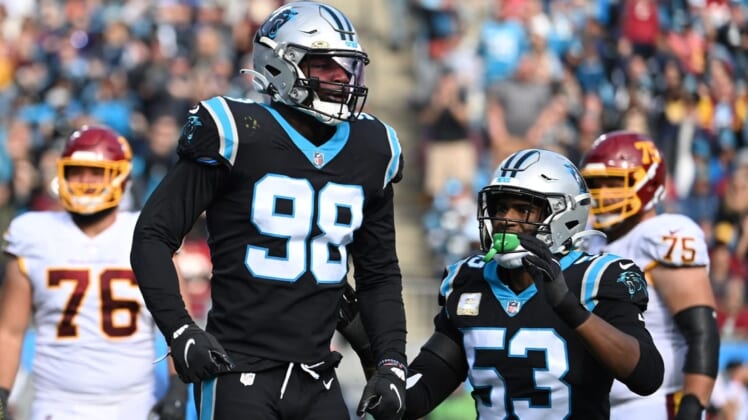 Nov 21, 2021; Charlotte, North Carolina, USA; Carolina Panthers defensive end Marquis Haynes (98) reacts with defensive end Brian Burns (53) after sacking Washington Football Team quarterback Taylor Heinicke (4) (not pictured) in the second quarter at Bank of America Stadium. Mandatory Credit: Bob Donnan-USA TODAY Sports