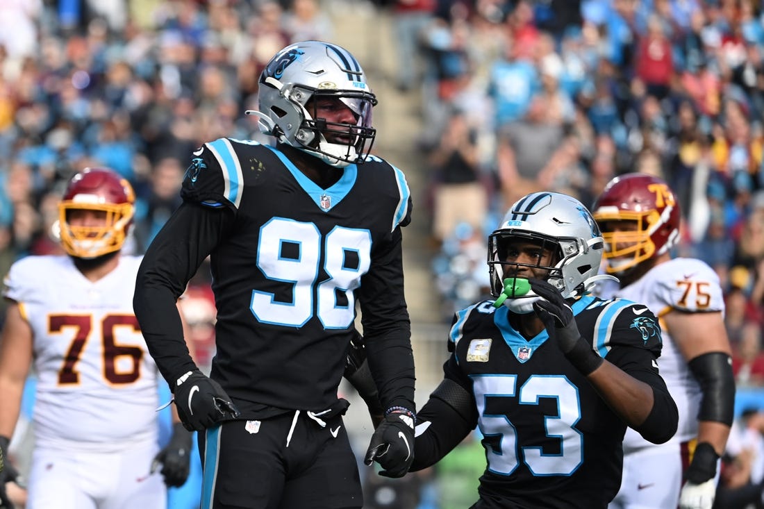 Nov 21, 2021; Charlotte, North Carolina, USA; Carolina Panthers defensive end Marquis Haynes (98) reacts with defensive end Brian Burns (53) after sacking Washington Football Team quarterback Taylor Heinicke (4) (not pictured) in the second quarter at Bank of America Stadium. Mandatory Credit: Bob Donnan-USA TODAY Sports