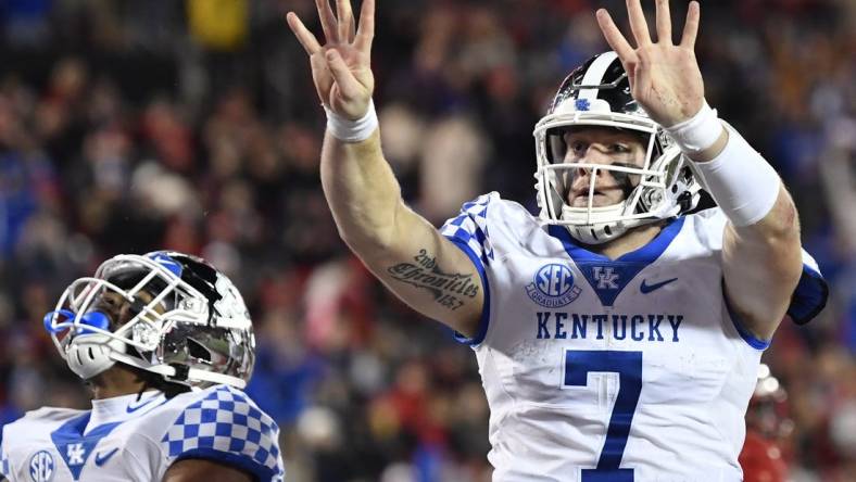 Nov 27, 2021; Louisville, Kentucky, USA;  Kentucky Wildcats quarterback Will Levis (7) celebrates after scoring his fourth touchdown against the Louisville Cardinals during the second half at Cardinal Stadium. Kentucky won 52-21. Mandatory Credit: Jamie Rhodes-USA TODAY Sports