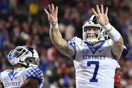 Nov 27, 2021; Louisville, Kentucky, USA;  Kentucky Wildcats quarterback Will Levis (7) celebrates after scoring his fourth touchdown against the Louisville Cardinals during the second half at Cardinal Stadium. Kentucky won 52-21. Mandatory Credit: Jamie Rhodes-USA TODAY Sports