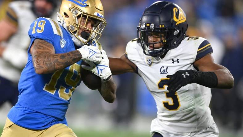 Nov 27, 2021; Pasadena, California, USA;   UCLA Bruins running back Kazmeir Allen (19) is stopped by California Golden Bears safety Elijah Hicks (3) just short of the goal line after a pass reception in the second half at the Rose Bowl. Mandatory Credit: Jayne Kamin-Oncea-USA TODAY Sports