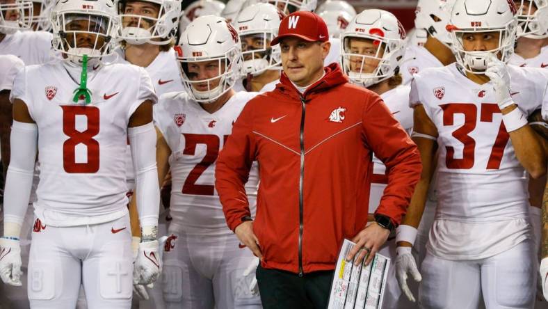 Nov 26, 2021; Seattle, Washington, USA; Washington State Cougars head coach Jake Dickert stands outside the locker room with wide receiver Calvin Jackson Jr. (8), running back Max Borghi (21) and linebacker Justus Rogers (37) before kickoff against the Washington Huskies at Alaska Airlines Field at Husky Stadium. Mandatory Credit: Joe Nicholson-USA TODAY Sports