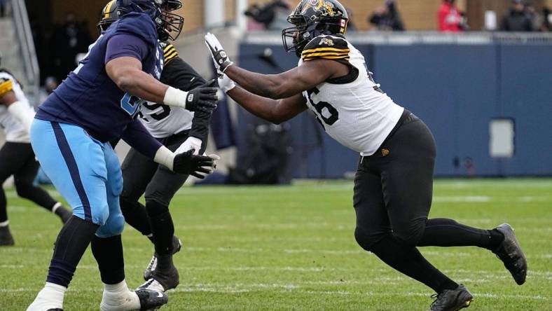 Dec 5, 2021; Toronto, Ontario, CAN; Toronto Argonauts offensive lineman Martez Ivey (62) sets up to block Hamilton Tiger-Cats defensive end Ja'Gared Davis (56)  during the Canadian Football League Eastern Conference Final game at BMO Field. Mandatory Credit: John E. Sokolowski-USA TODAY Sports