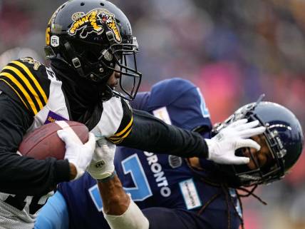 Dec 5, 2021; Toronto, Ontario, CAN; Hamilton Tiger-Cats wide receiver Brandon Banks (16) and Toronto Argonauts defensive back Jalen Collins (7) after a pass reception during the Canadian Football League Eastern Conference Final game at BMO Field. Mandatory Credit: John E. Sokolowski-USA TODAY Sports