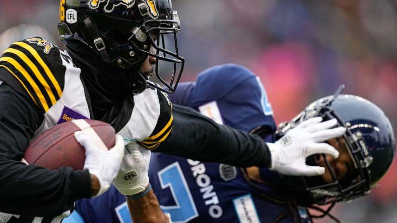 Dec 5, 2021; Toronto, Ontario, CAN; Hamilton Tiger-Cats wide receiver Brandon Banks (16) and Toronto Argonauts defensive back Jalen Collins (7) after a pass reception during the Canadian Football League Eastern Conference Final game at BMO Field. Mandatory Credit: John E. Sokolowski-USA TODAY Sports