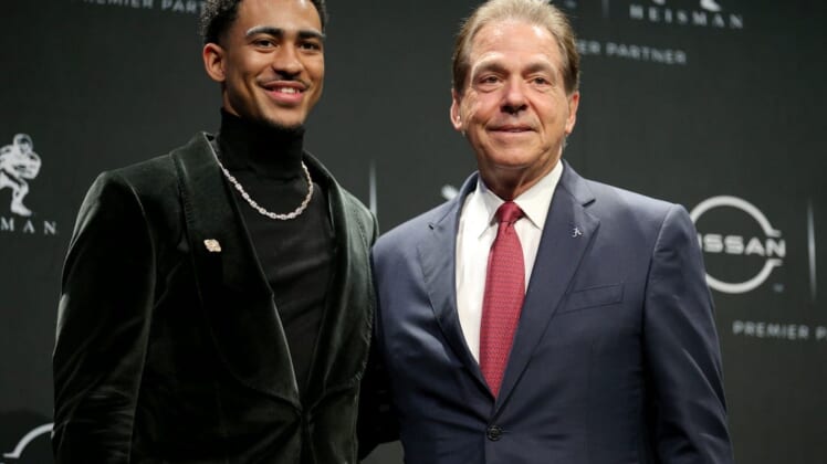 Dec 11, 2021; New York, NY, USA; 2021 Heisman winner Alabama quarterback Bryce Young (left) poses for pictures with head coach Nick Saban during a press conference at the New York Marriott Marquis in New York City. Mandatory Credit: Brad Penner-USA TODAY Sports