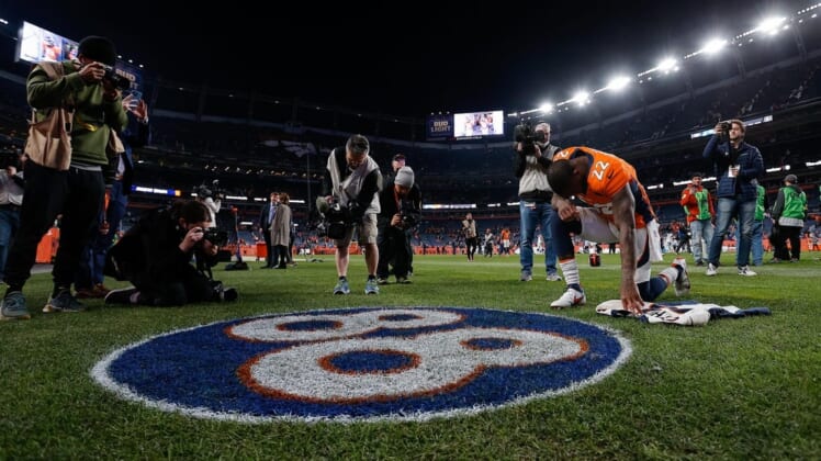 Dec 12, 2021; Denver, Colorado, USA; Denver Broncos safety Kareem Jackson (22) kneels next to the numbers of former Denver Broncos player Demaryius Thomas (not pictured) after the game against the Detroit Lions at Empower Field at Mile High. Mandatory Credit: Isaiah J. Downing-USA TODAY Sports
