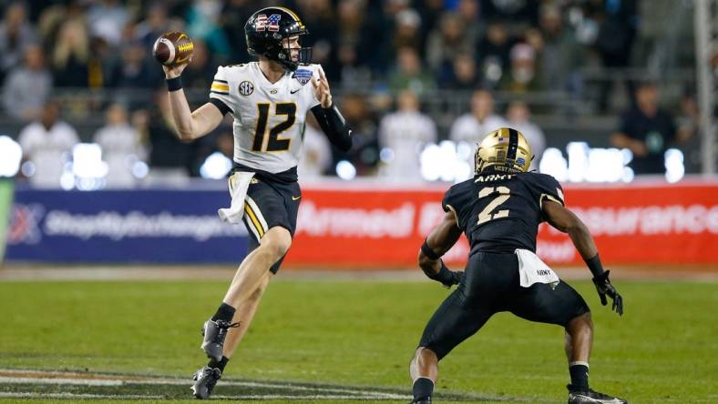 Dec 22, 2021; Fort Worth, Texas, USA; Missouri Tigers quarterback Brady Cook (12) throws with Army Black Knights linebacker Malkelm Morrison (2) defending during the third quarter of the 2021 Armed Forces Bowl at Amon G. Carter Stadium. Mandatory Credit: Andrew Dieb-USA TODAY Sports