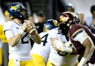 Dec 28, 2021; Phoenix, AZ, USA; West Virginia Mountaineers quarterback Jarret Doege (2) drops back to pass against the Minnesota Golden Gophers during the second half at Chase Field. Mandatory Credit: Joe Camporeale-USA TODAY Sports