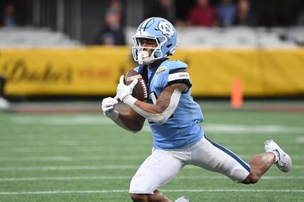 Dec 30, 2021; Charlotte, NC, USA; North Carolina Tar Heels wide receiver Josh Downs (11) catches the ball in the second quarter during the 2021 Duke's Mayo Bowl at Bank of America Stadium. Mandatory Credit: Bob Donnan-USA TODAY Sports