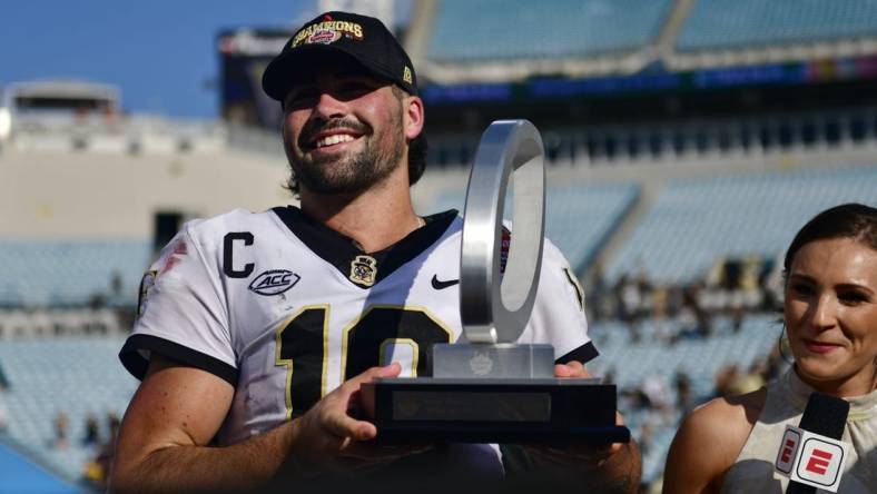 Wake Forest Demon Deacons quarterback Sam Hartman (10) holds up the MVP trophy after the game Friday, Dec. 31, 2021 at TIAA Bank Field in Jacksonville. The Wake Forest Demon Deacons and the Rutgers Scarlet Knights faced each other in the 2021 TaxSlayer Gator Bowl. Wake Forest defeated Rutgers 38-10. [Corey Perrine/Florida Times-Union]