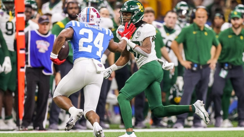 Jan 1, 2022; New Orleans, LA, USA;  Mississippi Rebels running back Snoop Conner (24) rushes against the Baylor Bears cornerback Mark Milton (37) during the second half of the 2022 Sugar Bowl at the Caesars Superdome. Mandatory Credit: Stephen Lew-USA TODAY Sports