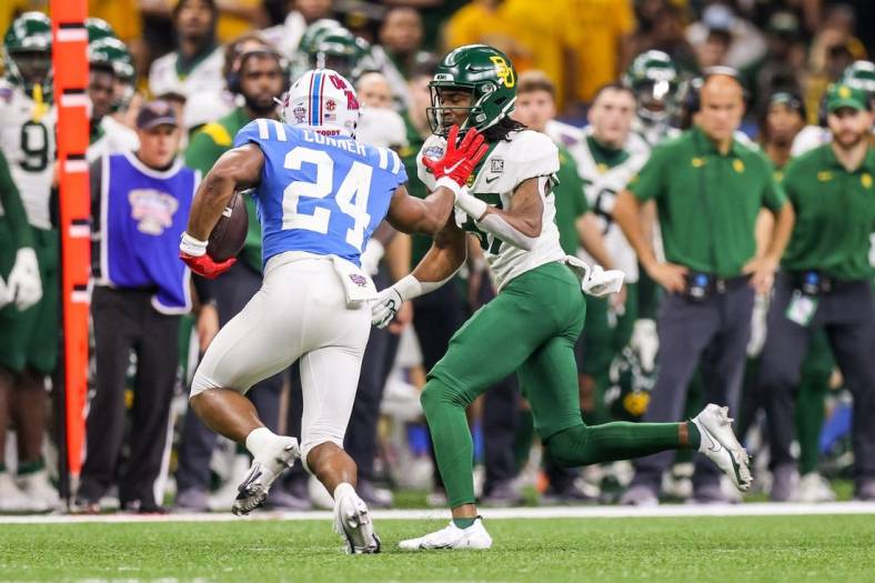 Jan 1, 2022; New Orleans, LA, USA;  Mississippi Rebels running back Snoop Conner (24) rushes against the Baylor Bears cornerback Mark Milton (37) during the second half of the 2022 Sugar Bowl at the Caesars Superdome. Mandatory Credit: Stephen Lew-USA TODAY Sports