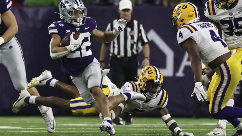 Jan 4, 2022; Houston, TX, USA; Kansas State Wildcats running back Deuce Vaughn (22) rushes against LSU Tigers safety Todd Harris Jr. (4) in the fourth quarter in the 2022 Texas Bowl at NRG Stadium. Mandatory Credit: Thomas Shea-USA TODAY Sports