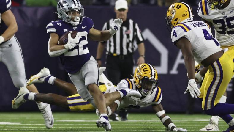 Jan 4, 2022; Houston, TX, USA; Kansas State Wildcats running back Deuce Vaughn (22) rushes against LSU Tigers safety Todd Harris Jr. (4) in the fourth quarter in the 2022 Texas Bowl at NRG Stadium. Mandatory Credit: Thomas Shea-USA TODAY Sports