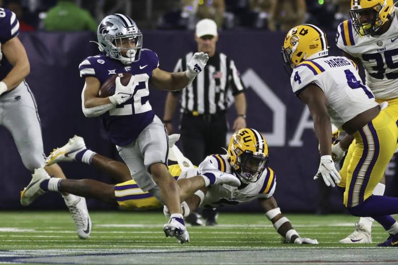 Jan 4, 2022; Houston, TX, USA; Kansas State Wildcats running back Deuce Vaughn (22) rushes against LSU Tigers safety Todd Harris Jr. (4) in the fourth quarter in the 2022 Texas Bowl at NRG Stadium. Mandatory Credit: Thomas Shea-USA TODAY Sports