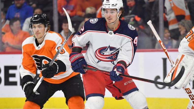 Jan 20, 2022; Philadelphia, Pennsylvania, USA; Columbus Blue Jackets center Alexandre Texier (42) battles for position with Philadelphia Flyers defenseman Travis Sanheim (6) during the first period at Wells Fargo Center. Mandatory Credit: Eric Hartline-USA TODAY Sports