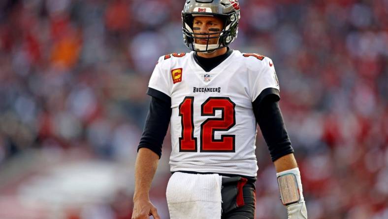 Jan 23, 2022; Tampa, Florida, USA; Tampa Bay Buccaneers quarterback Tom Brady (12) reacts during the first half against the Los Angeles Rams in a NFC Divisional playoff football game at Raymond James Stadium. Mandatory Credit: Nathan Ray Seebeck-USA TODAY Sports