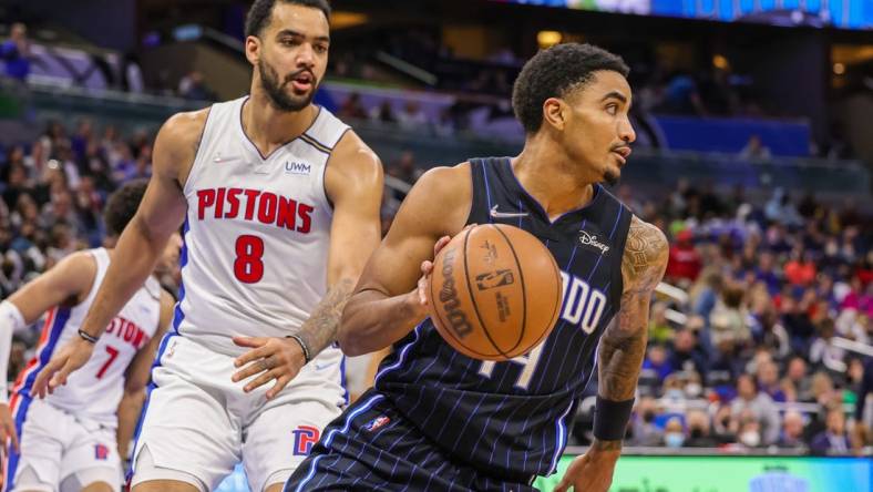 Jan 28, 2022; Orlando, Florida, USA; Orlando Magic guard Gary Harris (14) moves the ball past Detroit Pistons forward Trey Lyles (8) during the second half at Amway Center. Mandatory Credit: Mike Watters-USA TODAY Sports