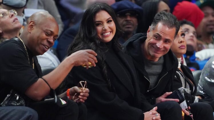 Feb 20, 2022; Cleveland, Ohio, USA; Vanessa Bryant sits between Dave Chapelle (left) and Lakers general manager Rob Pelinka (right) during the 2022 NBA All-Star Game at Rocket Mortgage FieldHouse. Mandatory Credit: Kyle Terada-USA TODAY Sports
