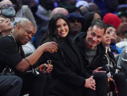 Feb 20, 2022; Cleveland, Ohio, USA; Vanessa Bryant sits between Dave Chapelle (left) and Lakers general manager Rob Pelinka (right) during the 2022 NBA All-Star Game at Rocket Mortgage FieldHouse. Mandatory Credit: Kyle Terada-USA TODAY Sports
