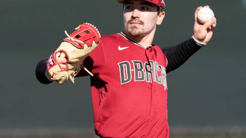 Feb 21, 2022; Scottsdale, Ariz., U.S.;  Diamondbacks minor league outfielder Corbin Carroll throws during a select training camp for minor-league players not covered by the Players Association at Salt River Fields. MLB continues to be in a lockout after the expiration of the collective bargaining agreement Dec. 2. Mandatory Credit: Michael Chow-Arizona Republic

Baseball Diamondbacks Select Minor League Camp