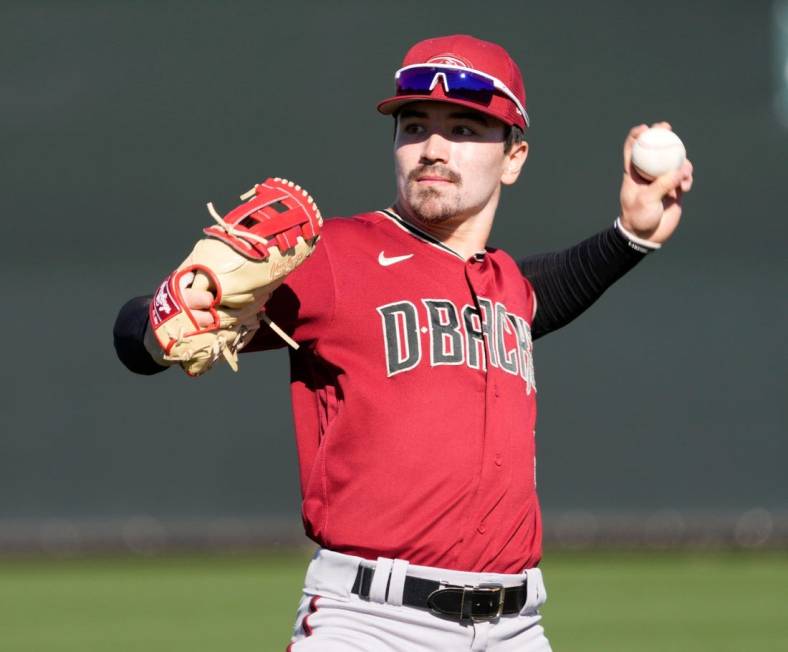 Feb 21, 2022; Scottsdale, Ariz., U.S.;  Diamondbacks minor league outfielder Corbin Carroll throws during a select training camp for minor-league players not covered by the Players Association at Salt River Fields. MLB continues to be in a lockout after the expiration of the collective bargaining agreement Dec. 2. Mandatory Credit: Michael Chow-Arizona Republic

Baseball Diamondbacks Select Minor League Camp
