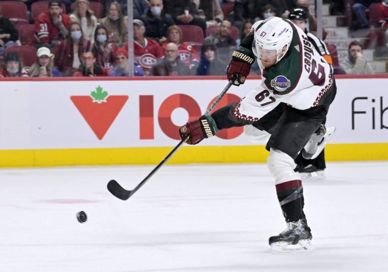 Mar 15, 2022; Montreal, Quebec, CAN; Arizona Coyotes forward Lawson Crouse (67) shoots the puck against the Montreal Canadiens during the first period at the Bell Centre. Mandatory Credit: Eric Bolte-USA TODAY Sports