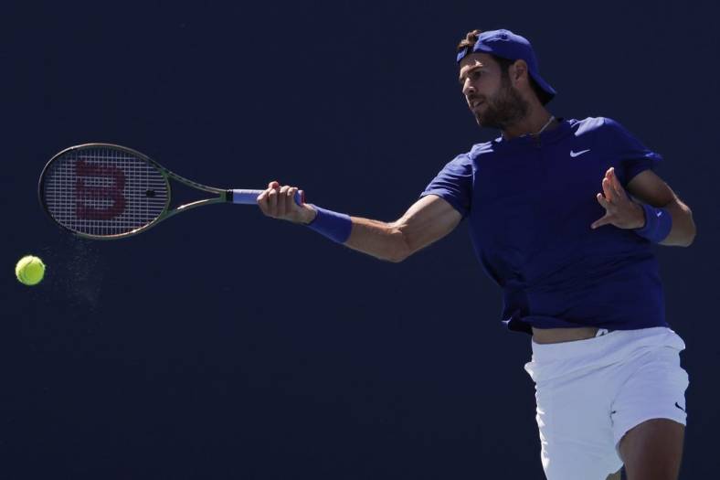 Mar 26, 2022; Miami Gardens, FL, USA; Karen Khachanov  hits a forehand against Tommy Paul (USA) (not pictured) in a second round men's singles match in the Miami Open at Hard Rock Stadium. Mandatory Credit: Geoff Burke-USA TODAY Sports