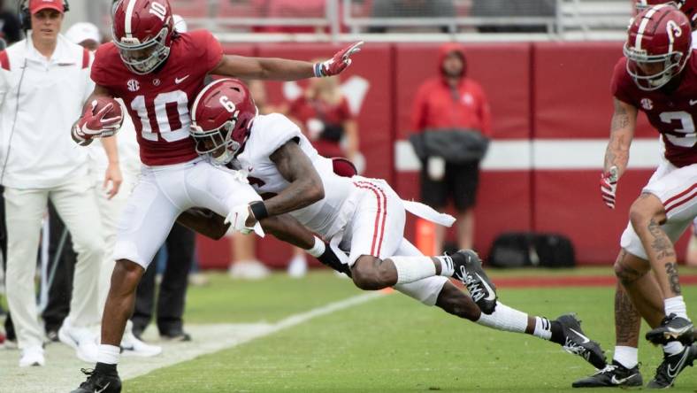 Apr 16, 2022; Tuscaloosa, Alabama, USA; Crimson wide receiver JoJo Earle (10) is driven out of bounds by White defensive back Khyree Jackson (6) during the A-Day game at Bryant-Denny Stadium. Mandatory Credit: Gary Cosby Jr.-USA TODAY Sports