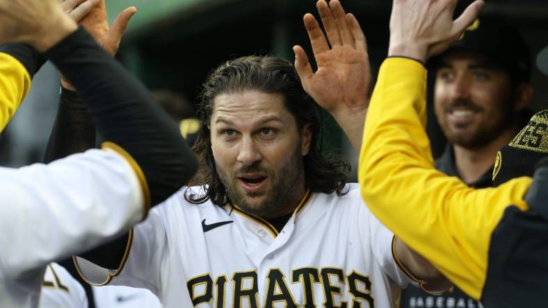 Apr 16, 2022; Pittsburgh, Pennsylvania, USA;  Pittsburgh Pirates left fielder Jake Marisnick (41) high-fives in the dugout after scoring a run against the Washington Nationals during the second inning at PNC Park. Mandatory Credit: Charles LeClaire-USA TODAY Sports