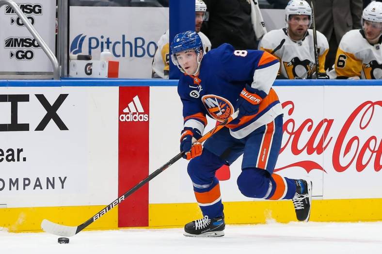 Apr 12, 2022; Elmont, New York, USA; New York Islanders defenseman Noah Dobson (8) skates with the puck against the Pittsburgh Penguins during the second period at UBS Arena. Mandatory Credit: Tom Horak-USA TODAY Sports