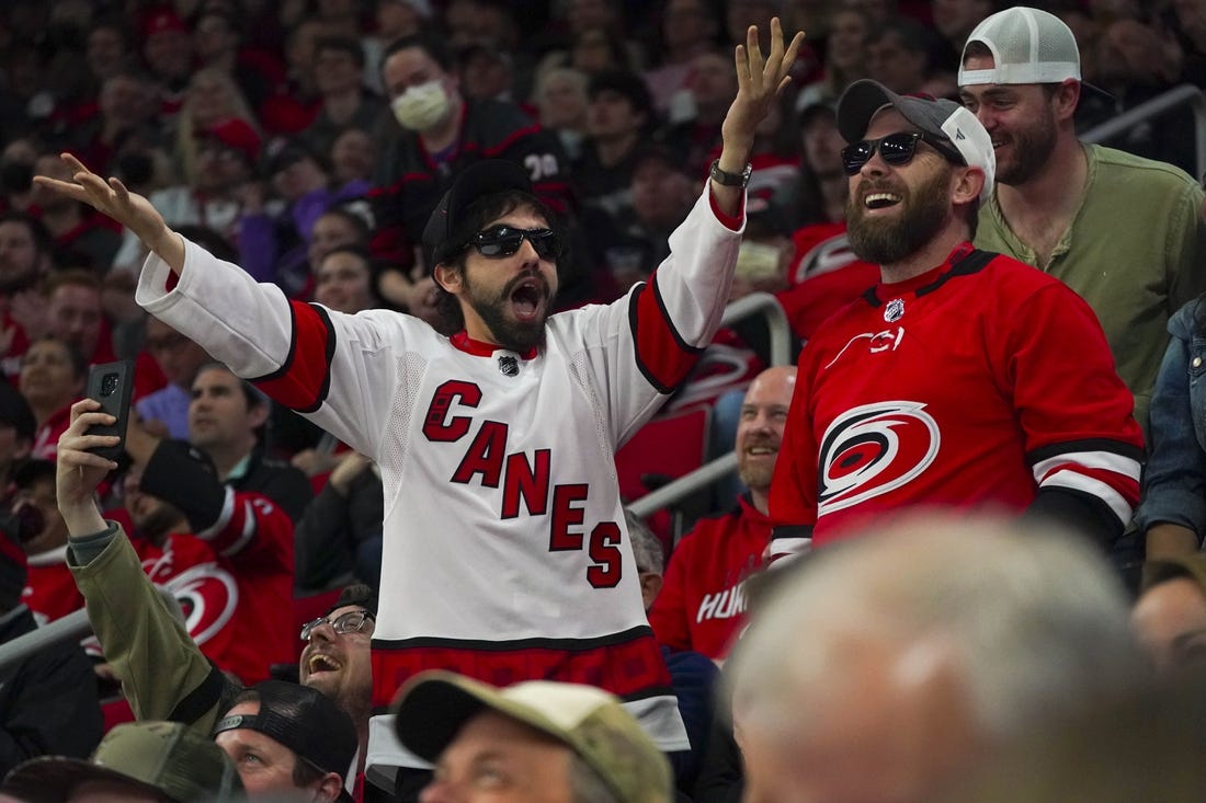 Apr 21, 2022; Raleigh, North Carolina, USA;  Carolina Hurricanes fans celebrate against the Winnipeg Jets during the third period at PNC Arena. Mandatory Credit: James Guillory-USA TODAY Sports