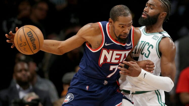 Apr 25, 2022; Brooklyn, New York, USA; Brooklyn Nets forward Kevin Durant (7) controls the ball against Boston Celtics guard Jaylen Brown (7) during the fourth quarter of game four of the first round of the 2022 NBA playoffs at Barclays Center. The Celtics defeated the Nets 116-112 to win the best of seven series 4-0. Mandatory Credit: Brad Penner-USA TODAY Sports