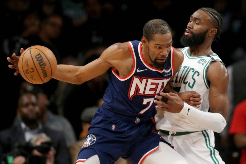 Apr 25, 2022; Brooklyn, New York, USA; Brooklyn Nets forward Kevin Durant (7) controls the ball against Boston Celtics guard Jaylen Brown (7) during the fourth quarter of game four of the first round of the 2022 NBA playoffs at Barclays Center. The Celtics defeated the Nets 116-112 to win the best of seven series 4-0. Mandatory Credit: Brad Penner-USA TODAY Sports