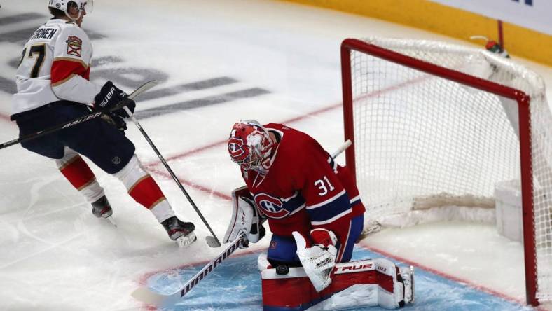 Apr 29, 2022; Montreal, Quebec, CAN; Montreal Canadiens goaltender Carey Price (31) makes a save against Florida Panthers center Eetu Luostarinen (27) during the first period at Bell Centre. Mandatory Credit: Jean-Yves Ahern-USA TODAY Sports