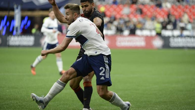 May 11, 2022; Vancouver, British Columbia, Canada;  Vancouver Whitecaps defender Erik Godoy (22) battles for the ball against Valour FC midfielder Moses Dyer (7) during the second half at BC Place. Mandatory Credit: Anne-Marie Sorvin-USA TODAY Sports